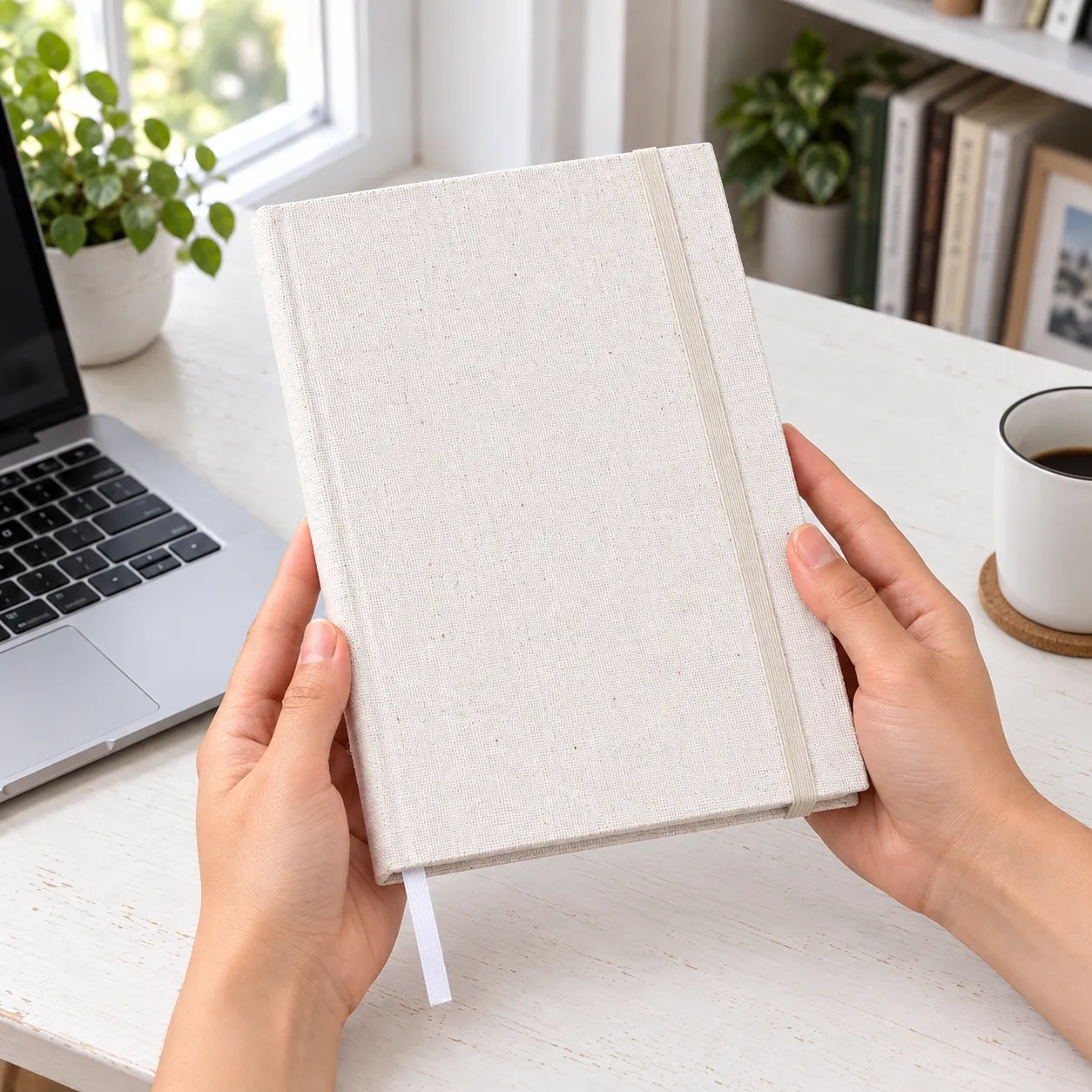 Cloth journal supported in two hands for scale